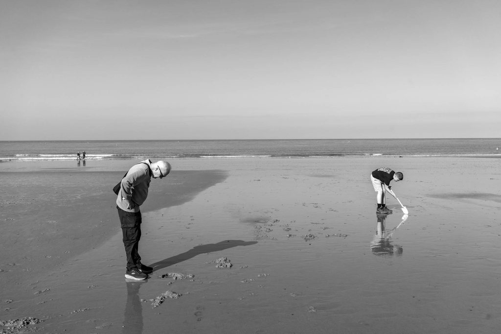 man and boy on sandy beach