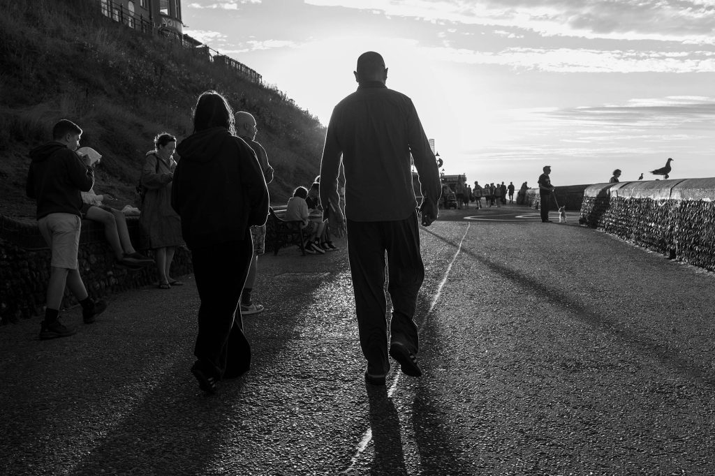 crowds and shadows on cromer promenade