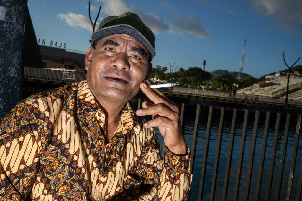 man smoking in labuan bajo
