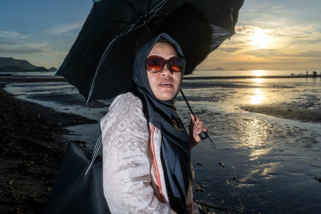 lady with umbrella at sunset