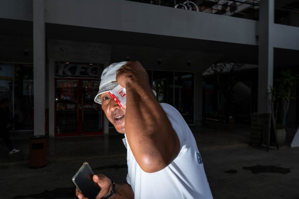 local man with phone and cigarettes, indonesia